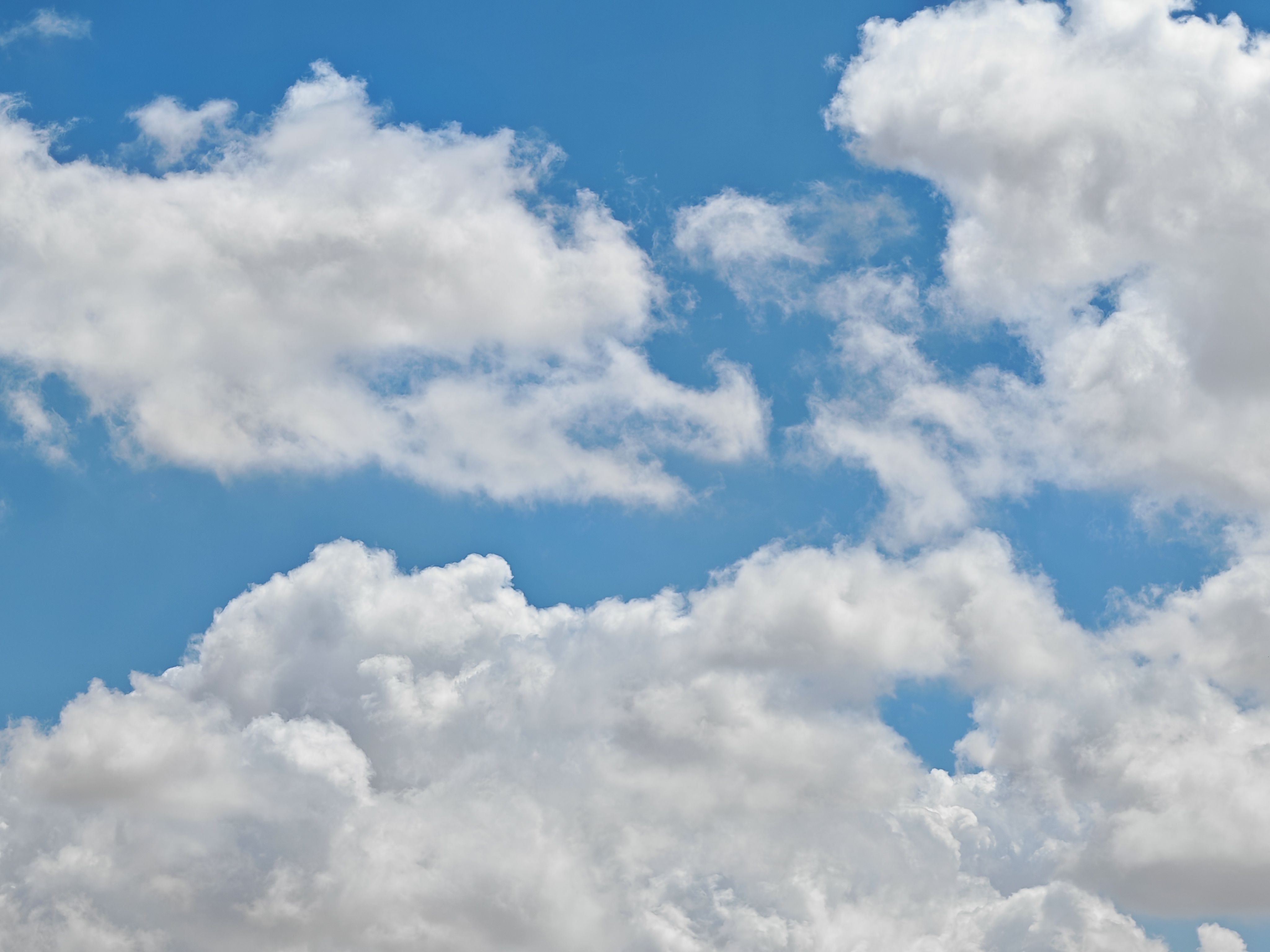 Fluffy White Clouds in a Bright Blue Sky · Free Stock Photo