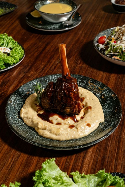 Free Deliciously plated lamb shank with mashed potatoes, a perfect gourmet meal centerpiece. Stock Photo