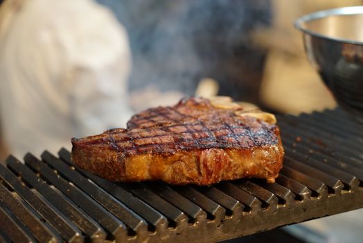 Juicy steak with grill marks sizzling on a barbecue grill, perfect for meat lovers.