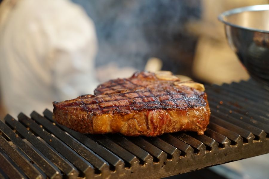 Steak cooking on a hot barbecue grill