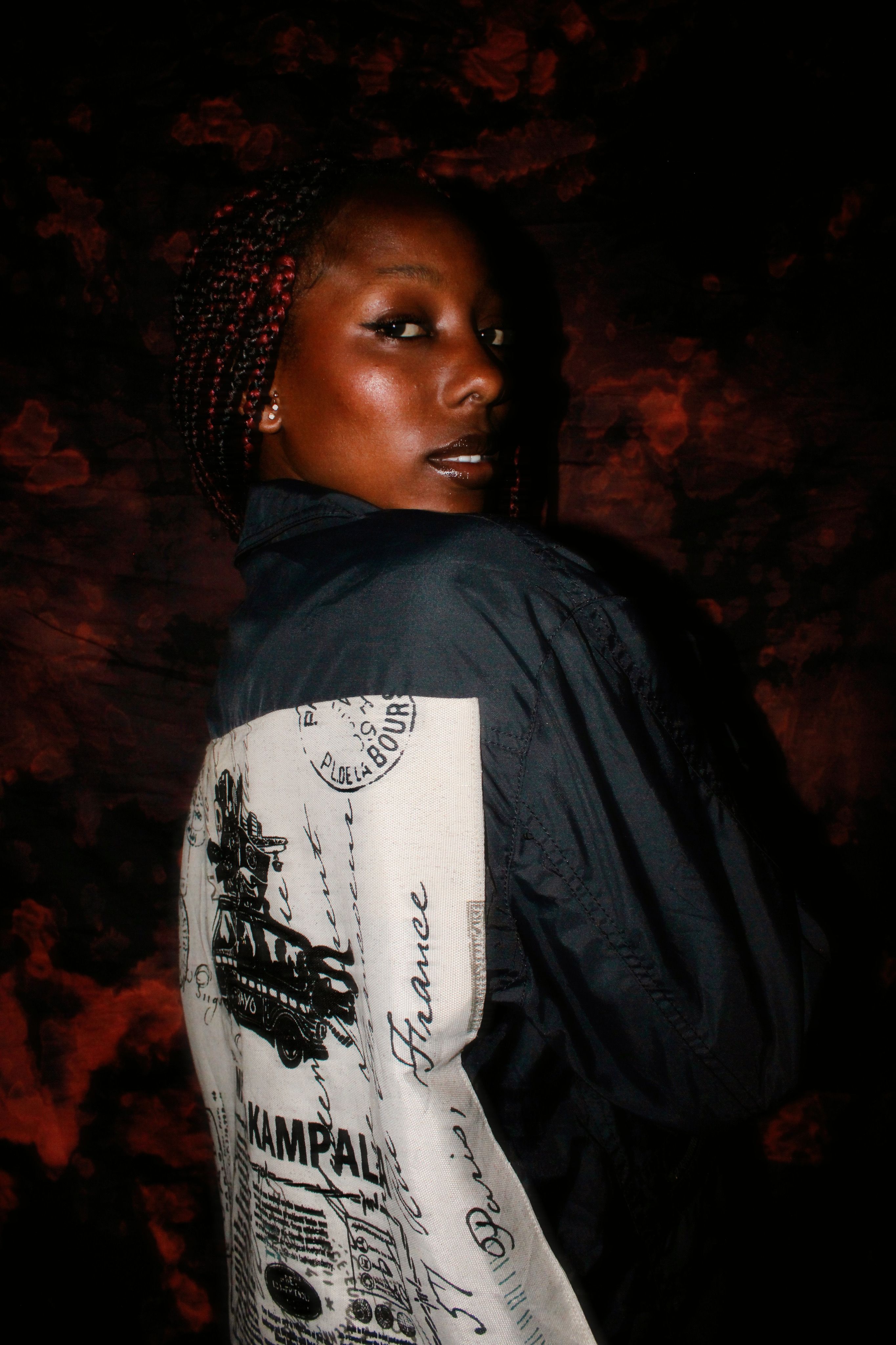 Fashionable portrait of a woman in a graphic outfit with braided hair, showcasing style.