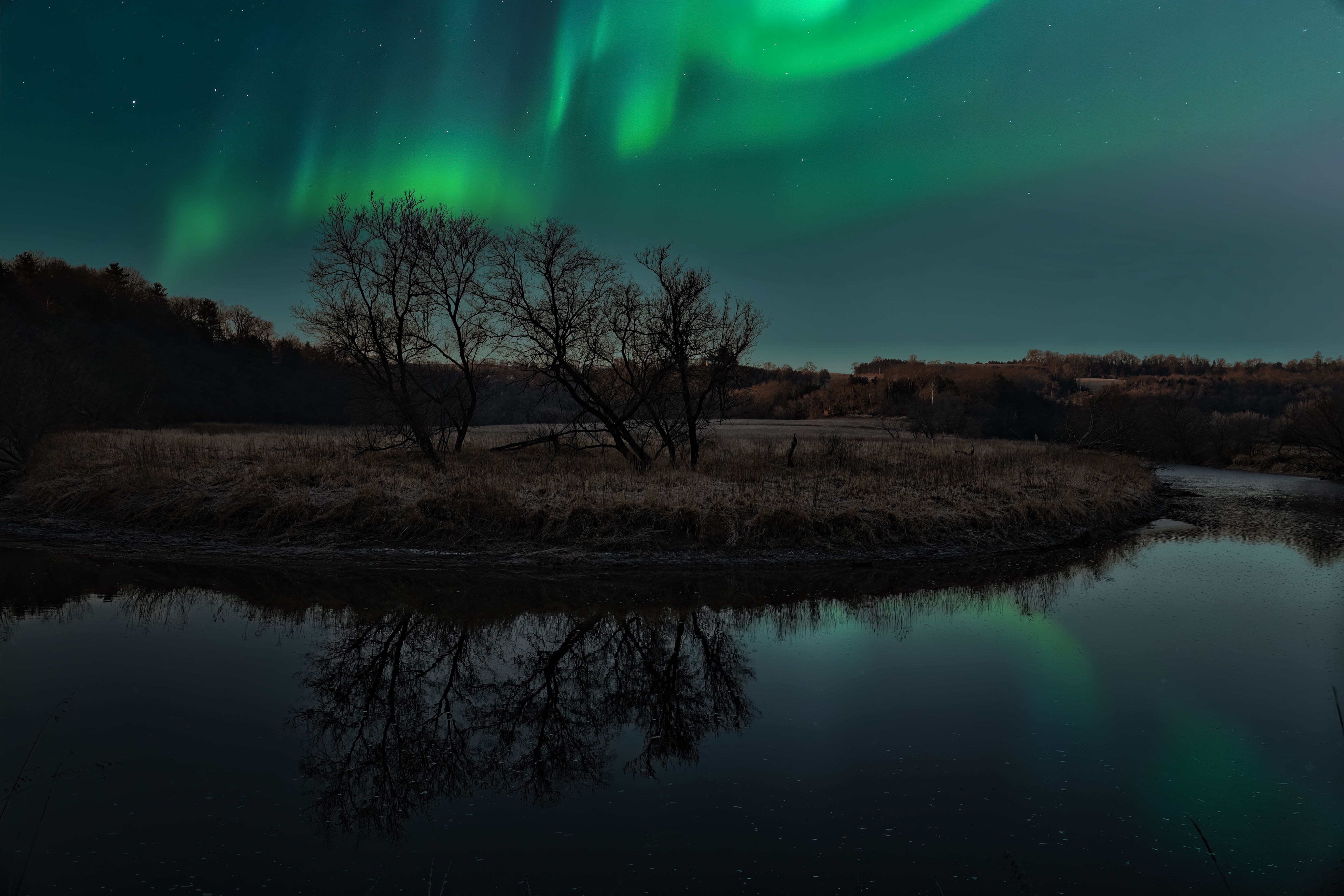 Stunning Northern Lights display over a serene lake in Fillmore, Minnesota.