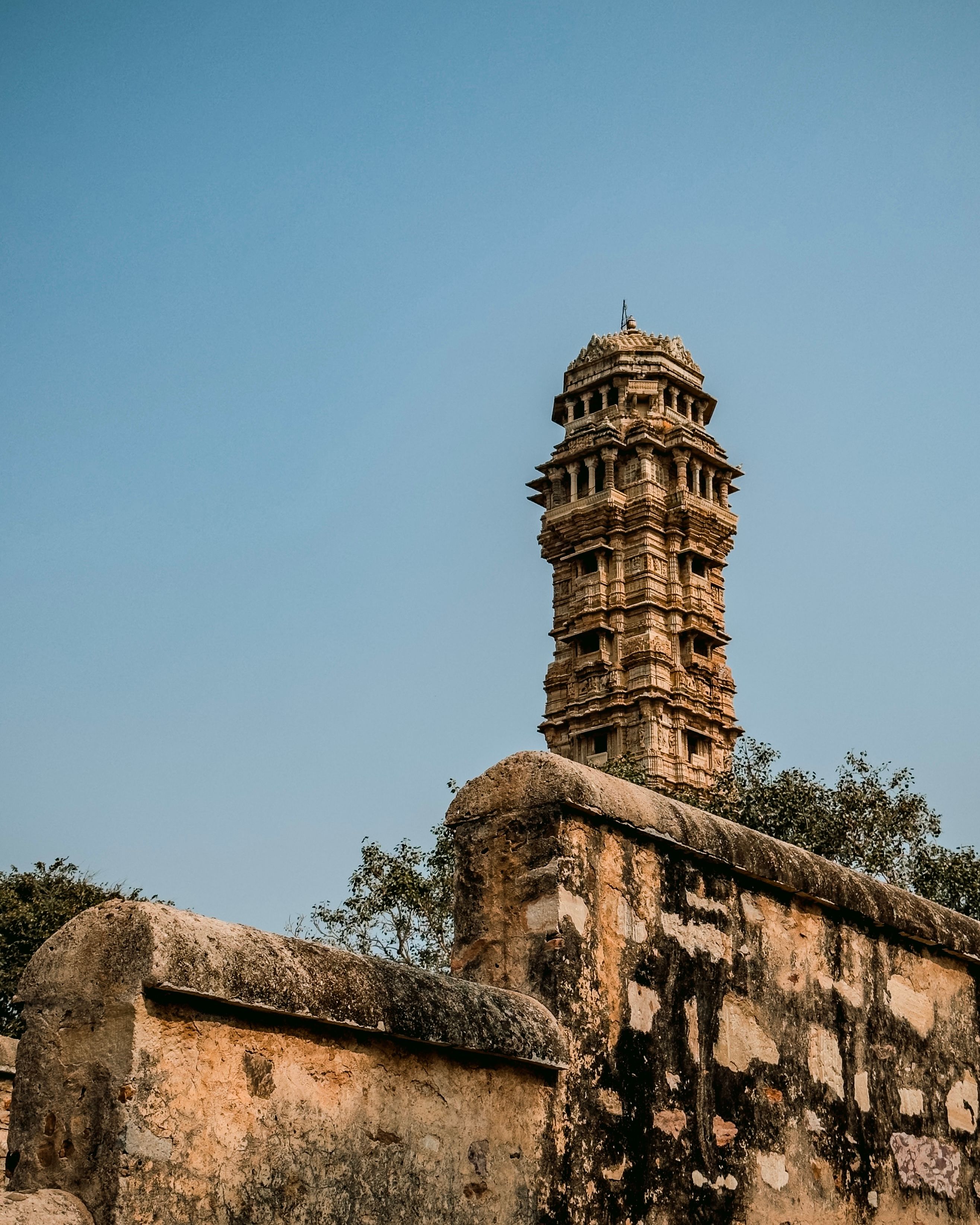 Vijay Stambh, a majestic Victory Tower in Chittorgarh, India, under a clear blue sky.