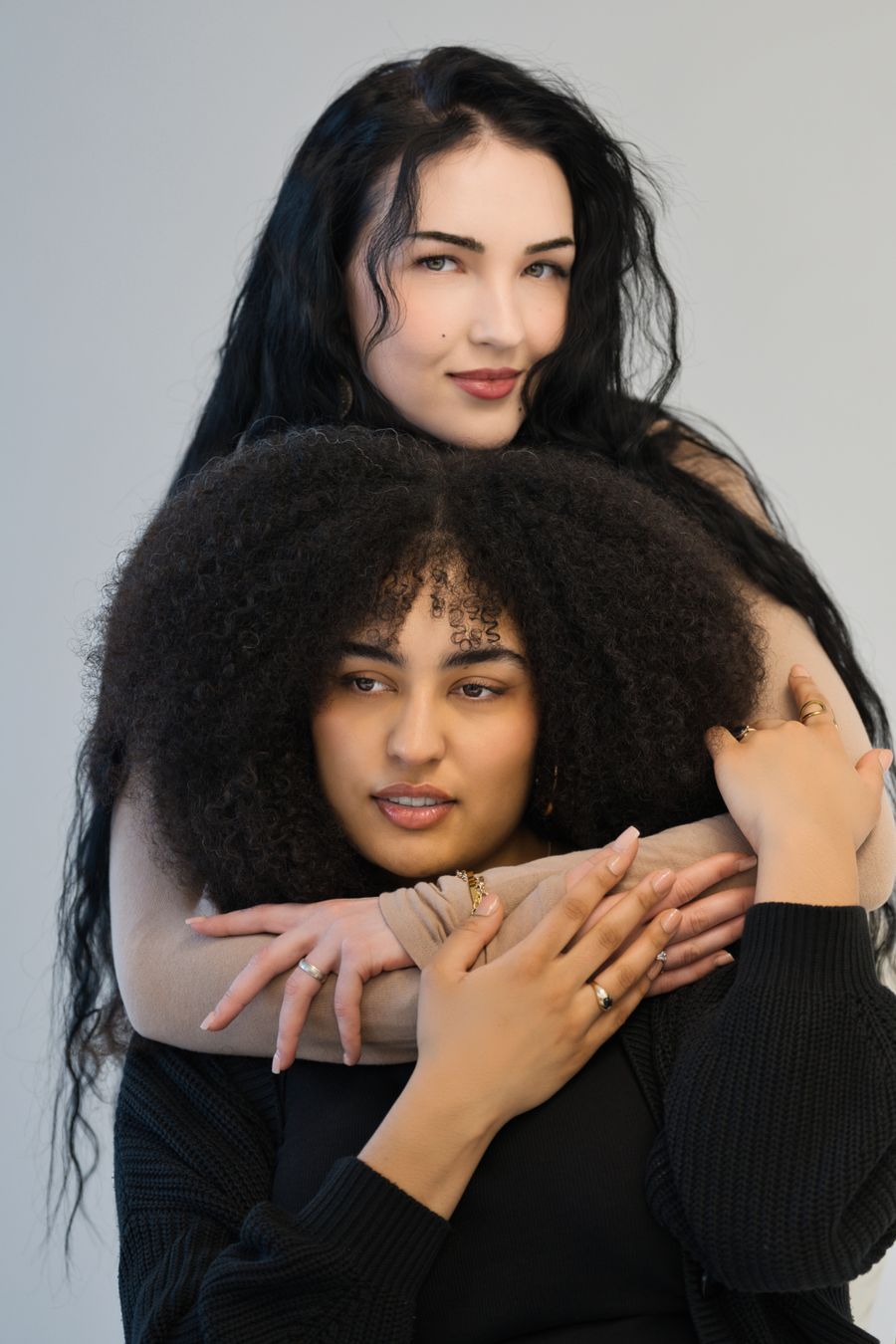 Two friends embracing in a studio portrait — photo by Travel with Lenses on Pexels