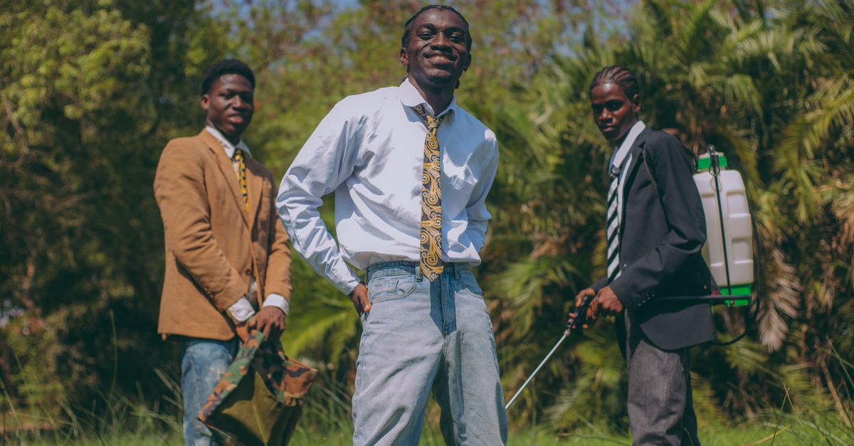 Students setting up a small sound system in a backyard in Ho, Ghana