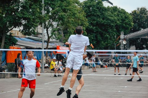 Free Energetic badminton game with multiple players in a city environment. Stock Photo
