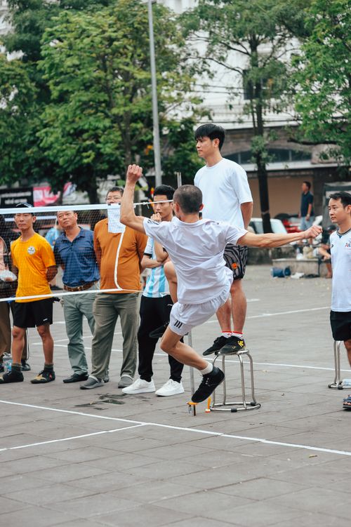 Free Group of men playing Sepak Takraw outdoors, showcasing dynamic sports action and teamwork. Stock Photo
