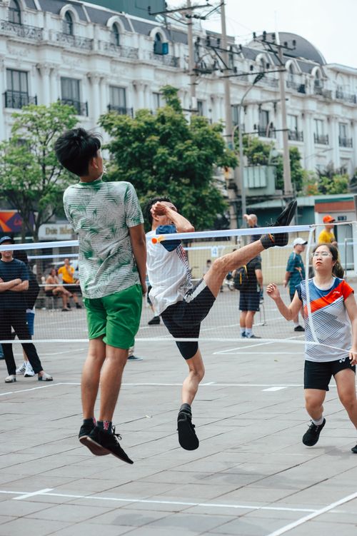Free Intense street volleyball game with players in mid-action, outdoors. Stock Photo