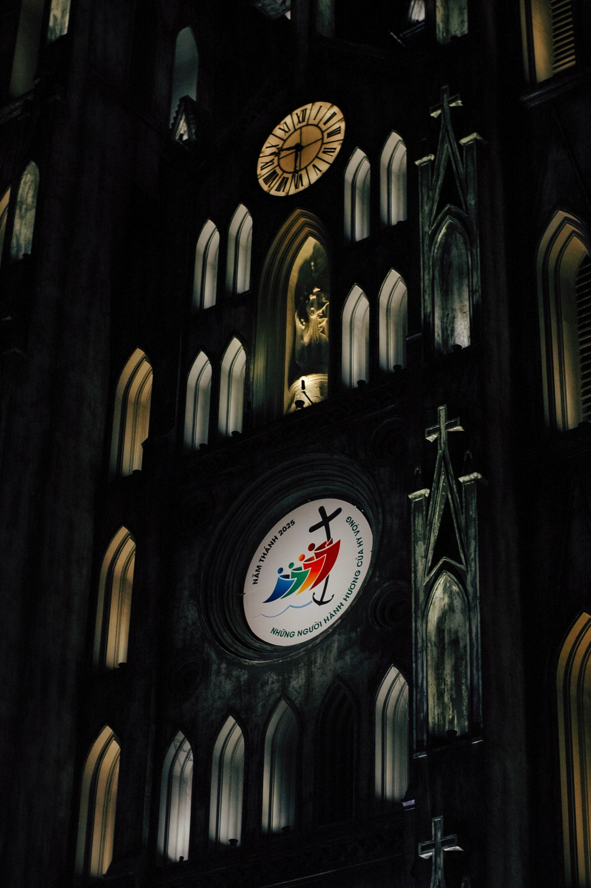 Gothic Cathedral Facade at Night with Illuminated Clock · Free Stock Photo