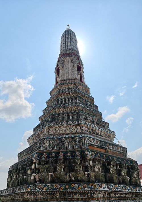 Free Dramatic image of Wat Arun against a bright sky, capturing its majestic architectural beauty. Stock Photo