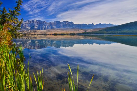 Calm lake with mountain reflections in Jasper National Park, Alberta, Canada.