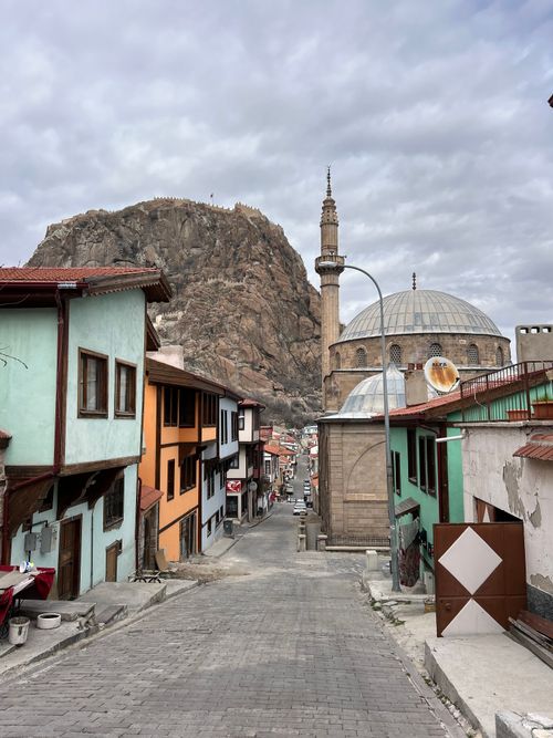 Free Charming alleyway in Afyonkarahisar with historical architecture and a rocky hill backdrop. Stock Photo