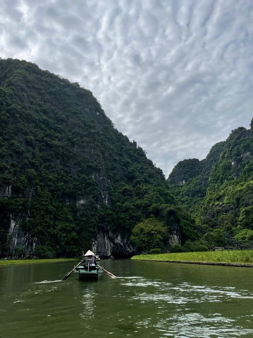 Free Experience the serene beauty of a boat ride amidst Vietnam's stunning limestone mountains. Stock Photo