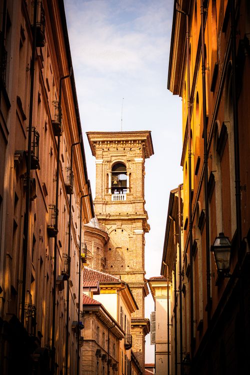 Free A stunning view of a historic bell tower framed by narrow streets in Turin, Italy. Stock Photo