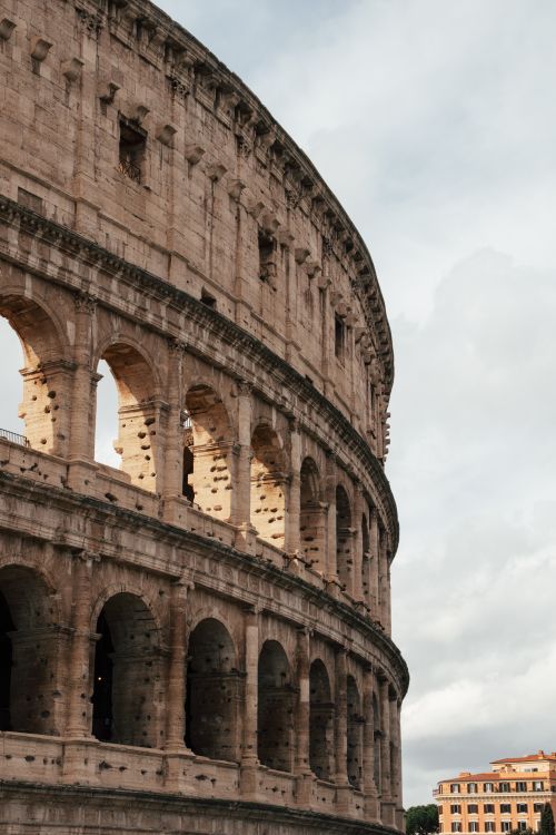 Free Capture of the Colosseum's ancient architecture in Rome, Italy, emphasizing its iconic Roman design. Stock Photo