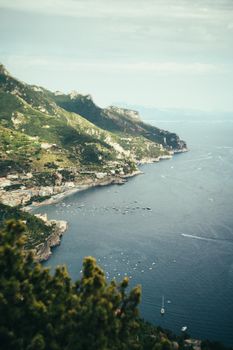 Breathtaking aerial view of the Amalfi Coast, Italy, showcasing cliffs, sea, and boats.