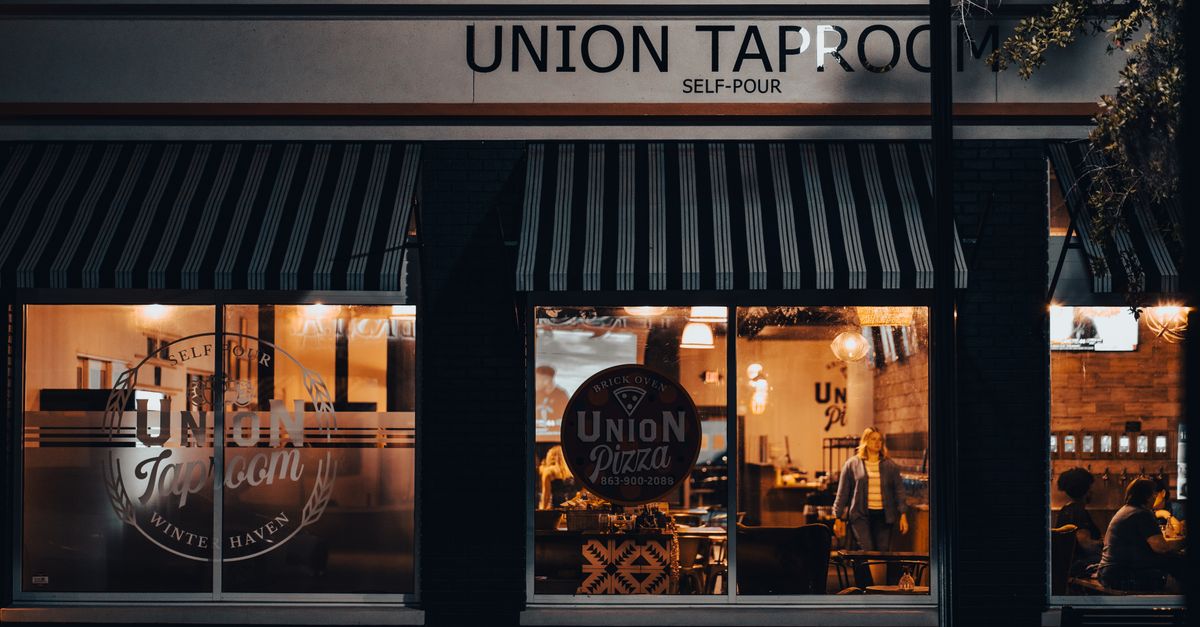 Street view of Union Taproom with warm night lighting and visible patrons inside.