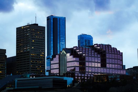 A stunning view of modern skyscrapers at twilight with reflective glass surfaces.