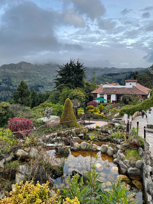 Free Beautiful mountain village landscape with lush gardens and traditional architecture. Stock Photo
