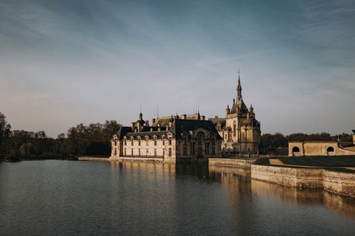 Free Explore the historic Château de Chantilly and its stunning waterfront architecture in Hauts-de-France. Stock Photo