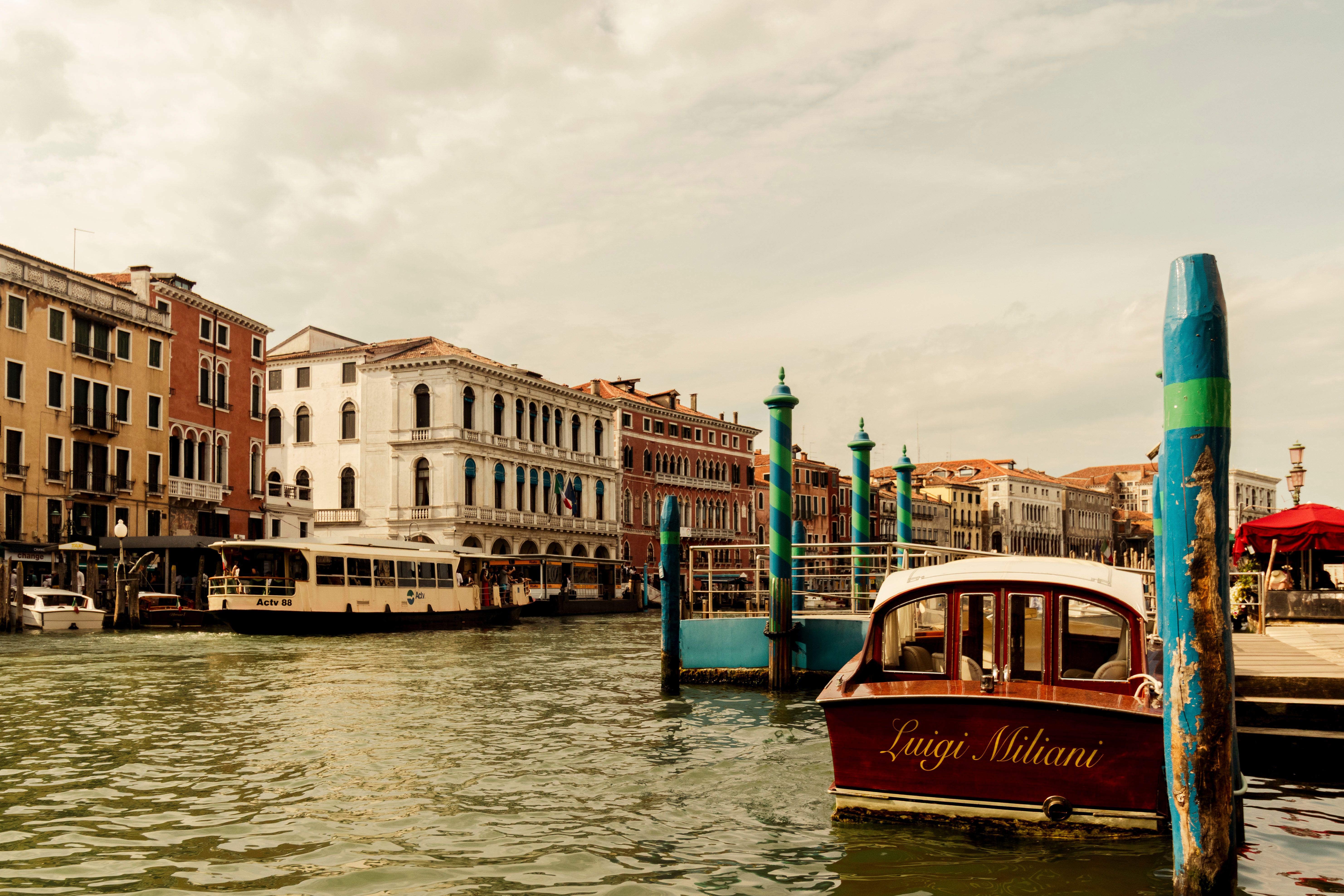 Charming view of Venice's Grand Canal with traditional buildings and boats on a sunny day.