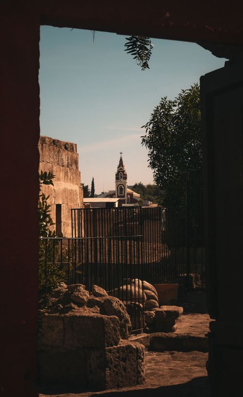 Free Glimpse of a historic church tower framed by an antique gate in Arequipa, Peru. Stock Photo
