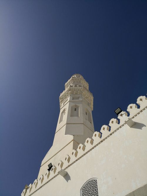 Free A historic minaret in Madinah, Saudi Arabia, set against a clear blue sky, showcasing Islamic architecture. Stock Photo
