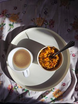 Delightful breakfast scene featuring a cup of coffee and a bowl of noodles.