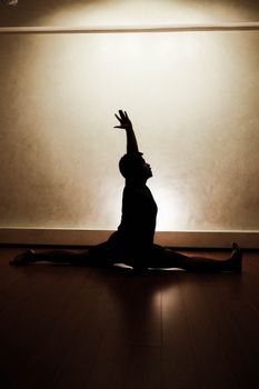 Silhouette of man doing yoga
