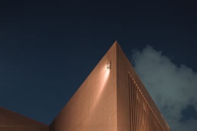 A sleek modern building with illuminated facade against a night sky ba — Photo by James Bat Barrera on Pexels