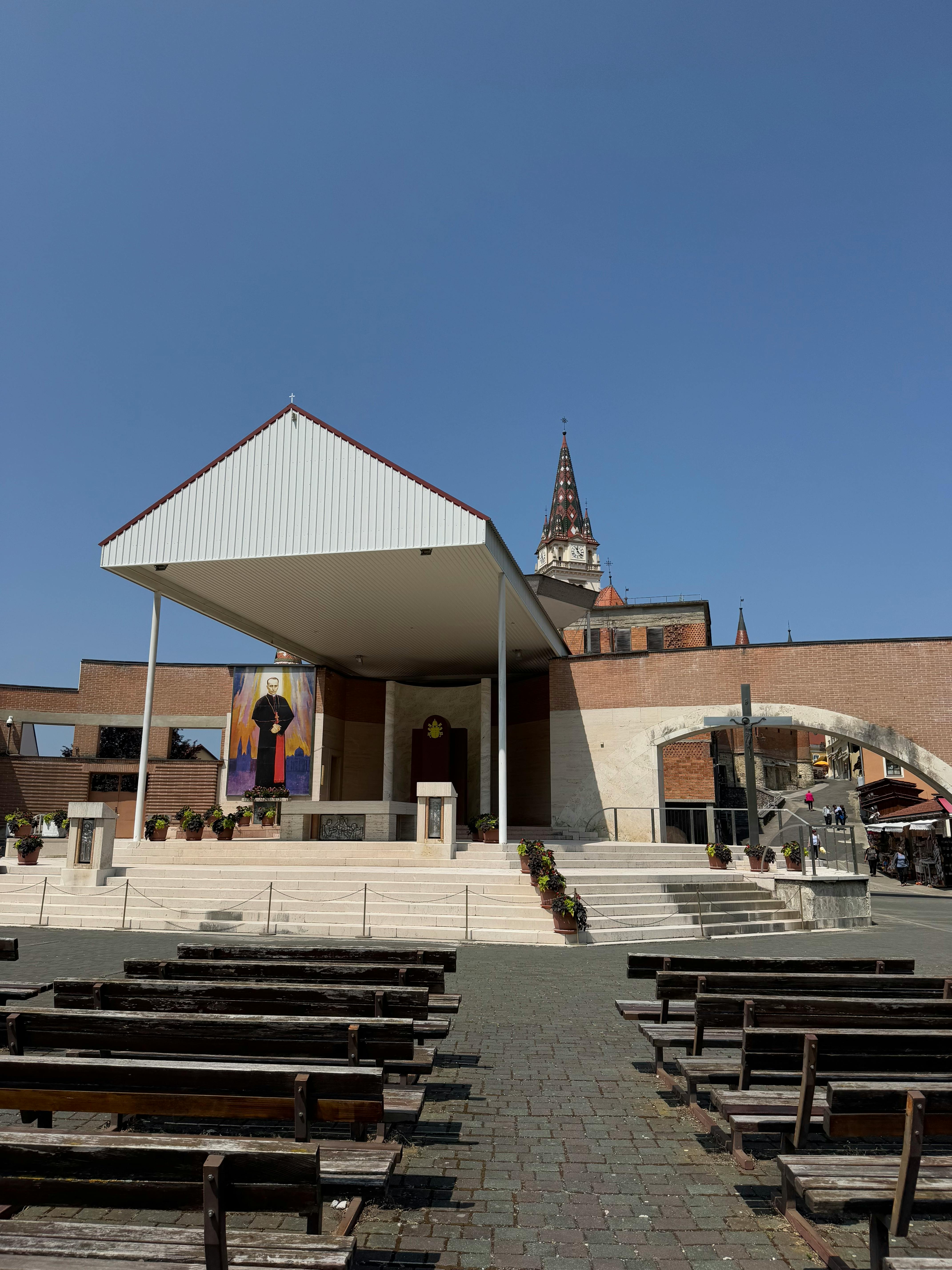 Outdoor altar at Marija Bistrica in Croatia, with benches and clear blue sky.