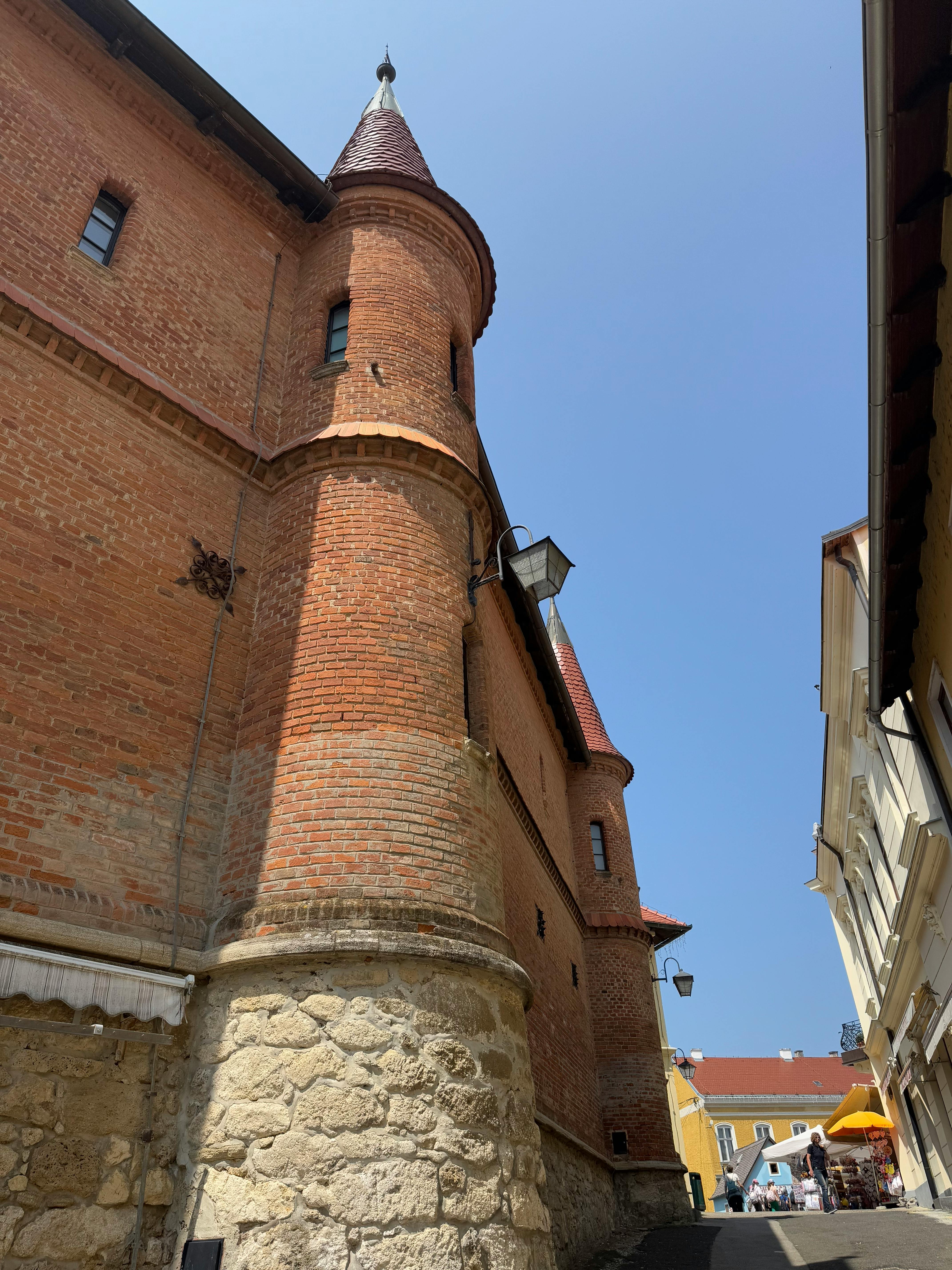 Charming brick architecture in Marija Bistrica, Croatia under a clear blue sky.