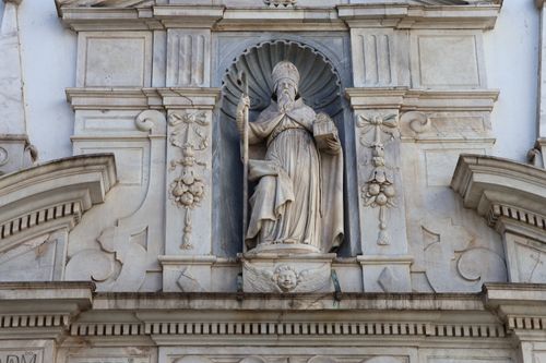 Free Detailed view of an ornate stone facade depicting a religious figure in Cádiz, Spain. Stock Photo