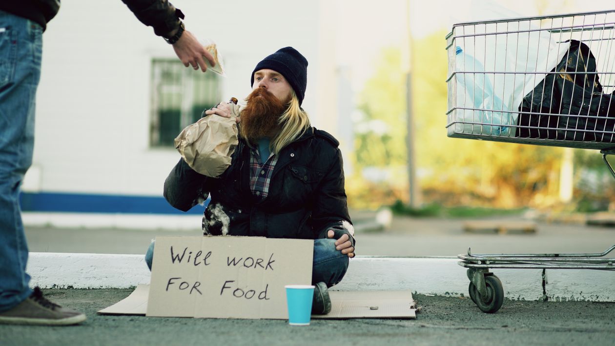 Homeless Person Receiving Food Donation · Free Stock Photo