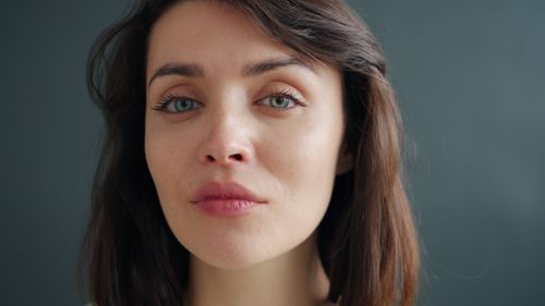 Free Close-up portrait of an adult woman with a neutral expression and natural lighting. Stock Photo