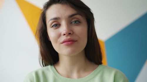 Free Close-up portrait of a woman with a colorful geometric background. Stock Photo