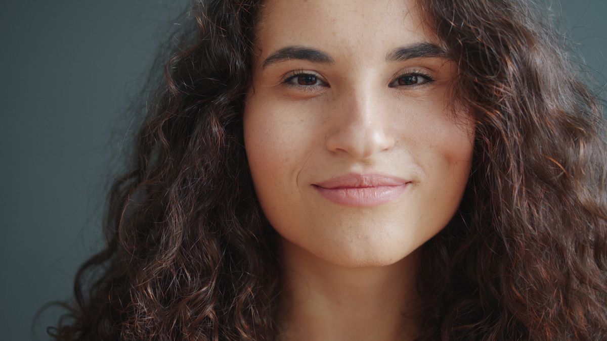 Portrait Photo of Smiling Woman with Brown Curly Hair · Free Stock Photo