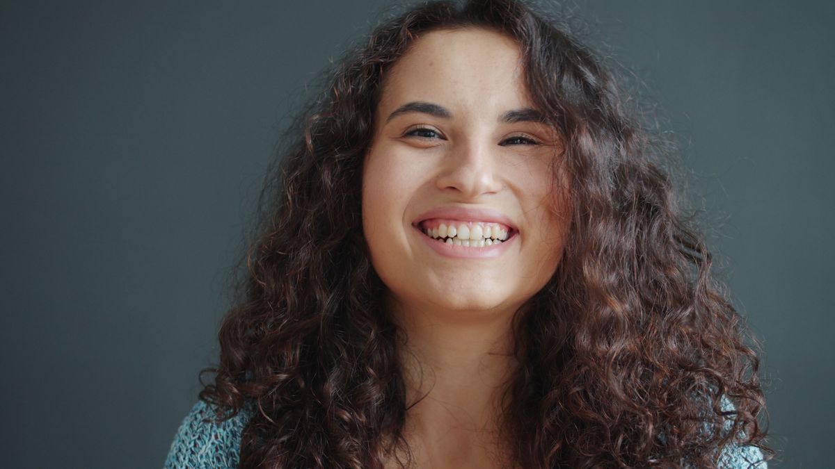 Portrait Photo of Smiling Woman with Brown Curly Hair · Free Stock Photo