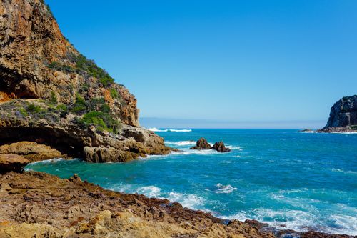 Free Vibrant coastal scene featuring rugged cliffs and turquoise sea, perfect for travel or nature themes. Stock Photo