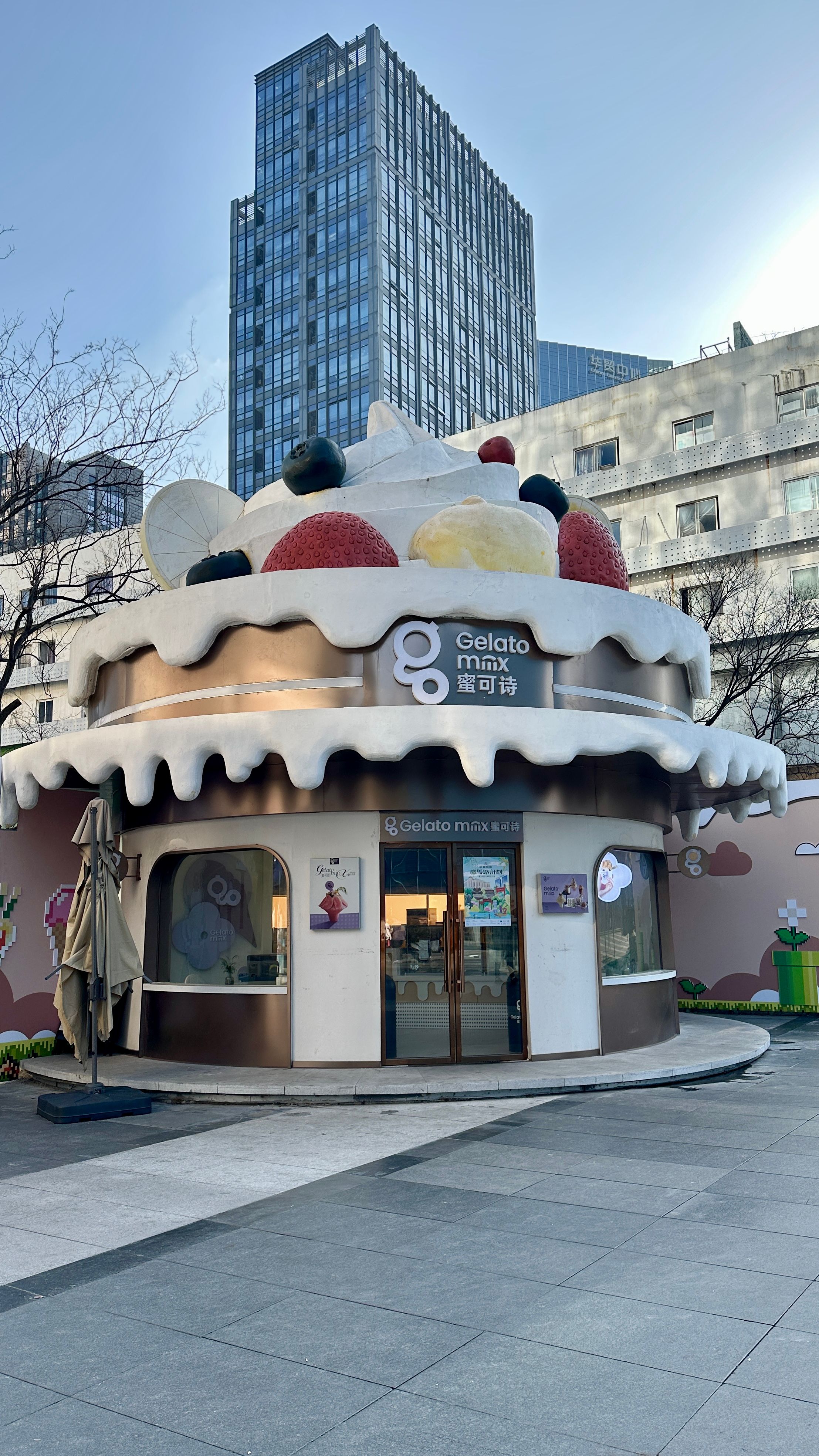 Ice cream-themed gelato shop with playful architecture in a vibrant city setting.