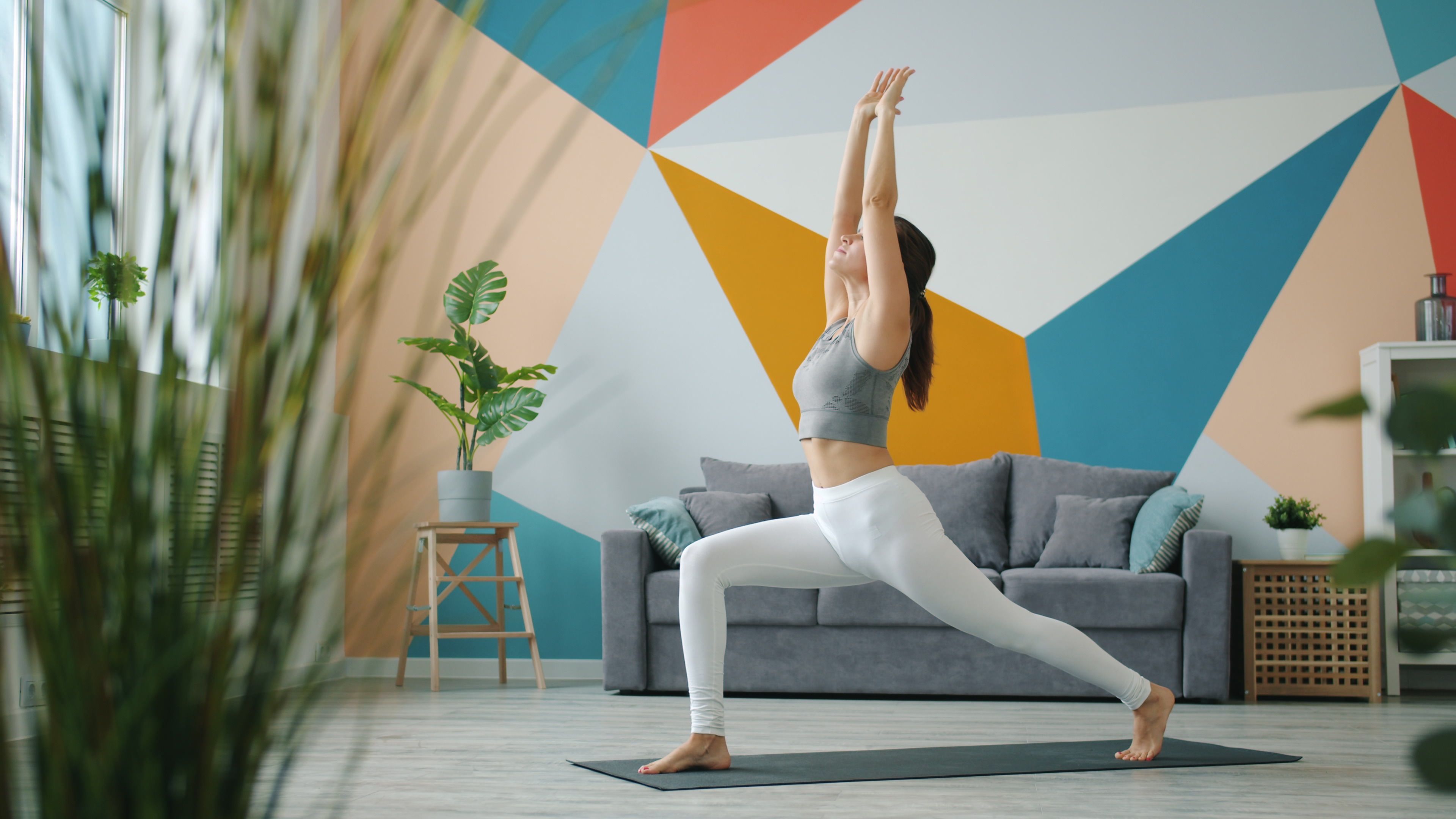 A resident practicing yoga in a private studio within a luxury apartment complex - apartments with gym