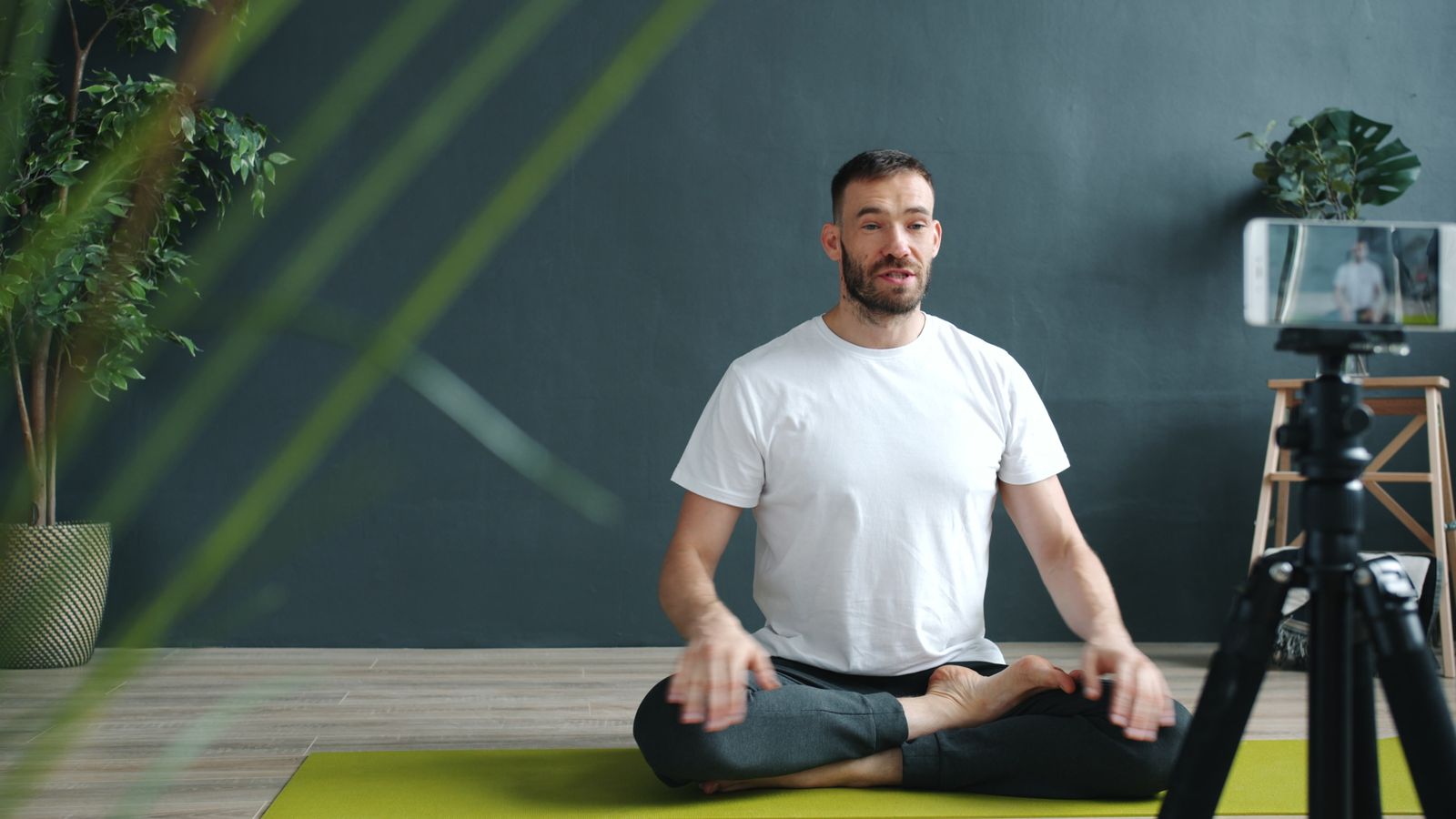 Fitness instructor leading a livestreamed workout class in real time