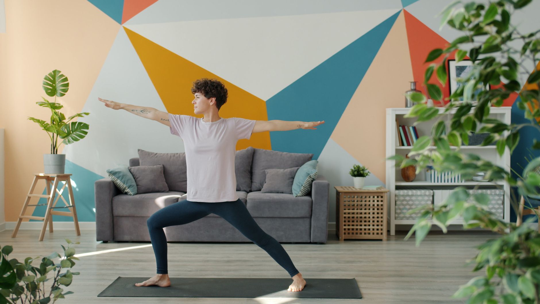 Adult practicing yoga in a stylish indoor setting with vibrant decor.
