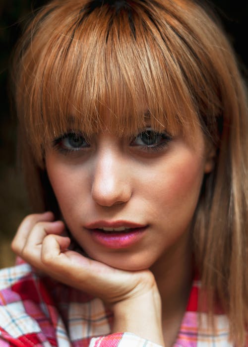 Woman with Brown Hair Resting Her Head on Her Chin