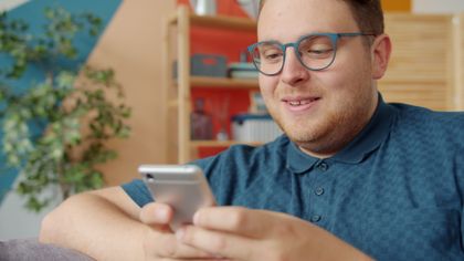 Man smiling at his phone