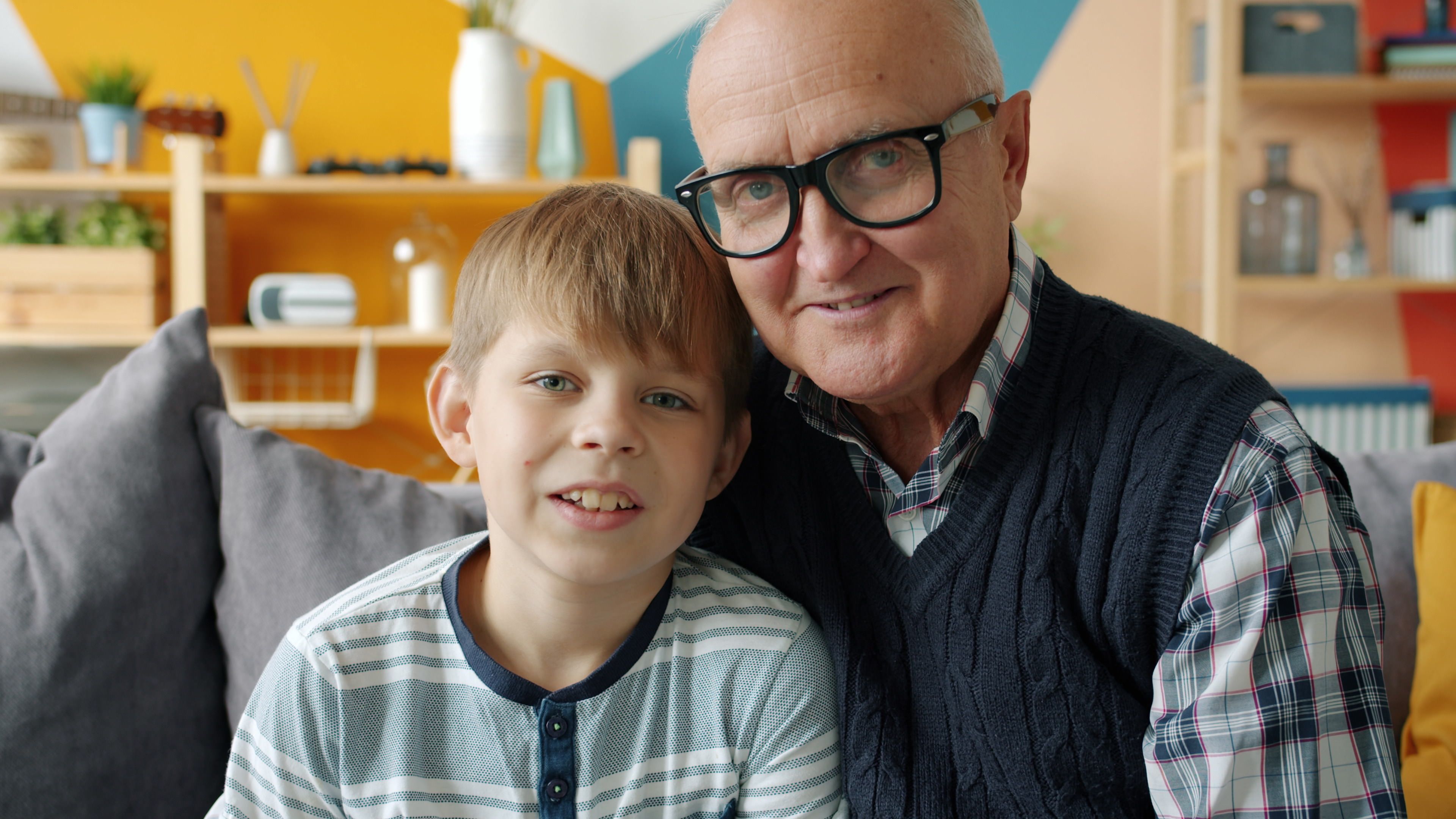 A grandfather and his grandson smiling together
