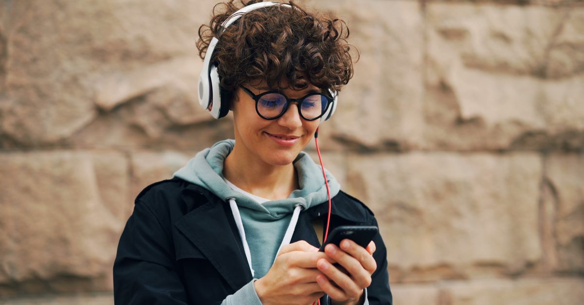 Gen Z young person looking stressed at phone with multiple buy now pay later apps