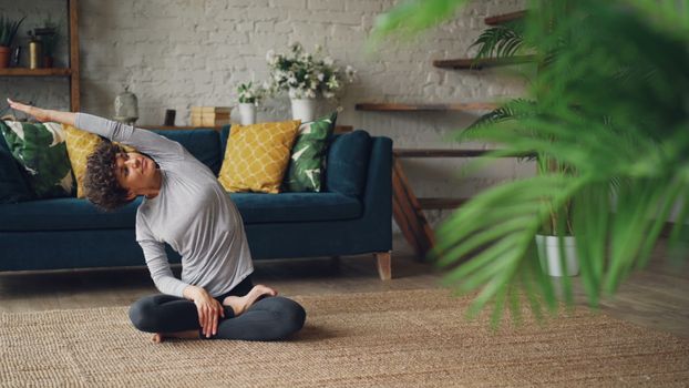 Peaceful yoga practice in a stylish living room setting, emphasizing relaxation and mindfulness.