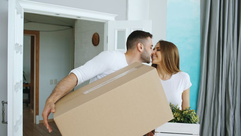 Smiling SwiftHaul Moving professionals standing with packed boxes in Philadelphia, Pennsylvania