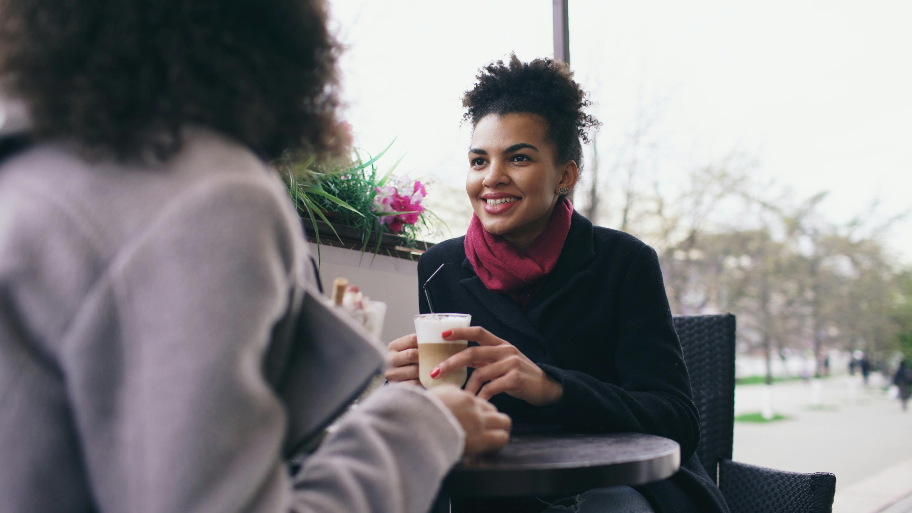 ADHD crying easily adhd & emotions adhd — two friends talking at cafe cozy warm afternoon light